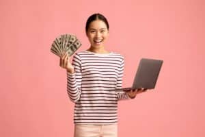 femme heureuse de gagner de l’argent tout en se formant en ligne